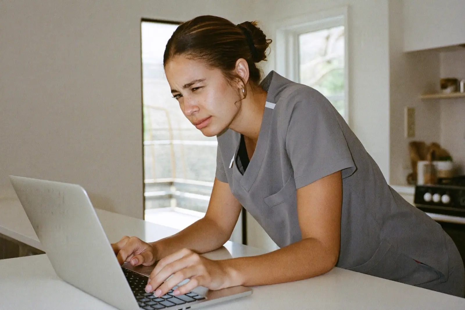 A new grad nurse highlights a nursing job posting beside a checklist and magnifying glass